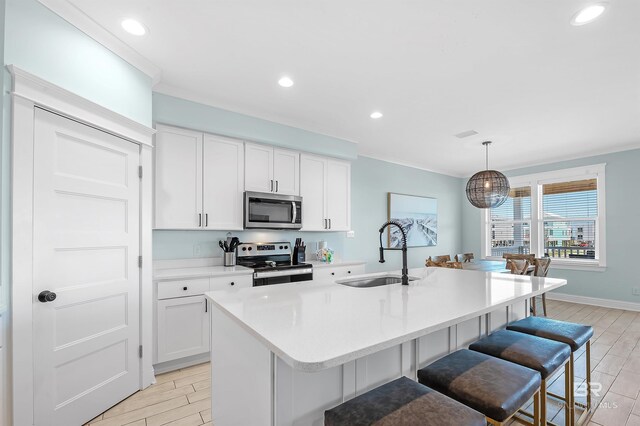 1337 W Lagoon Ave, Gulf Shores, AL 36542 - kitchen with white cabinetry, wood finish floors, a sink, and appliances with stainless steel finishes