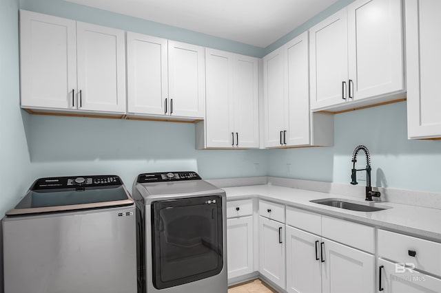 1337 W Lagoon Ave, Gulf Shores, AL 36542 - laundry room featuring washing machine and clothes dryer, cabinet space, and a sink