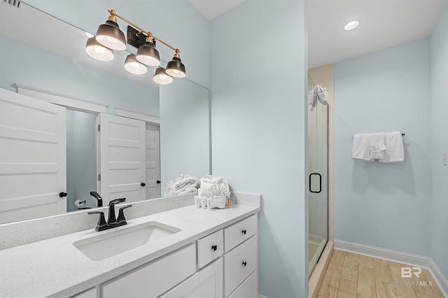 1337 W Lagoon Ave, Gulf Shores, AL 36542 - full bathroom featuring vanity, baseboards, wood finished floors, and a shower stall