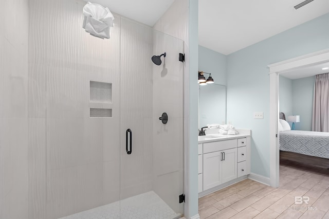 1337 W Lagoon Ave, Gulf Shores, AL 36542 - ensuite bathroom with vanity, a shower stall, visible vents, ensuite bathroom, and wood tiled floor