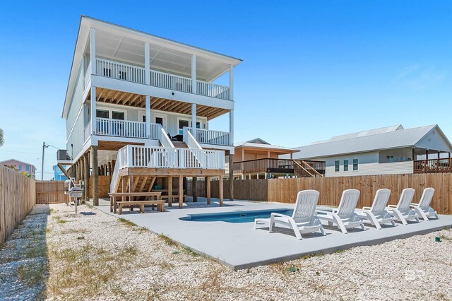 1337 W Lagoon Ave, Gulf Shores, AL 36542 - rear view of property featuring a fenced in pool, a fenced backyard, stairway, cooling unit, and a patio area
