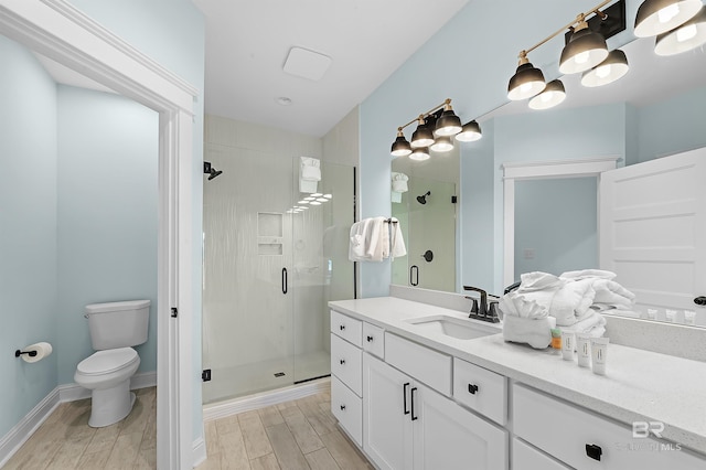 1337 W Lagoon Ave, Gulf Shores, AL 36542 - full bathroom featuring a stall shower, toilet, vanity, wood finish floors, and baseboards