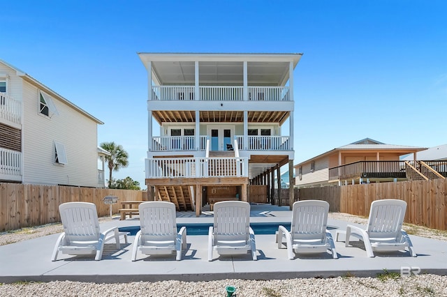 1337 W Lagoon Ave, Gulf Shores, AL 36542 - back of house featuring a fenced backyard, stairway, a patio area, and a pool