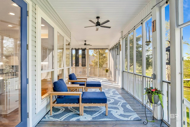 sunroom / solarium featuring ceiling fan