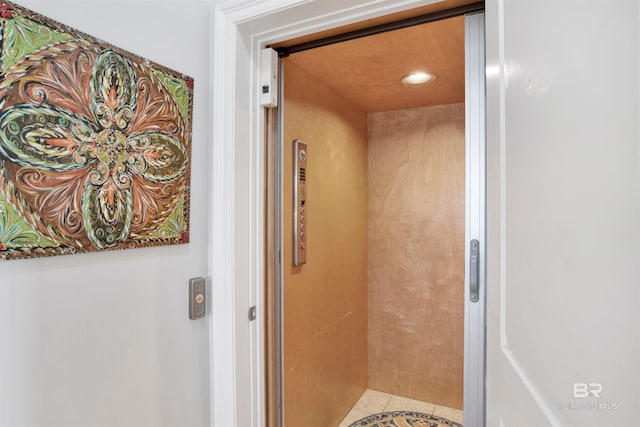 bathroom with tile patterned flooring and elevator