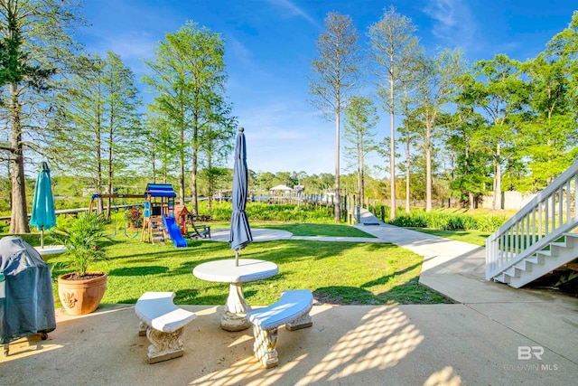 surrounding community with a lawn and a playground