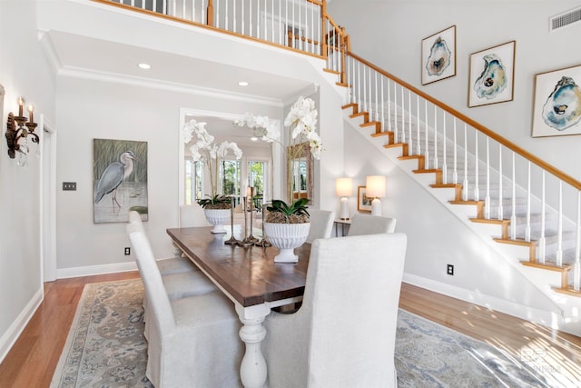 dining area featuring a chandelier, light hardwood / wood-style flooring, and ornamental molding