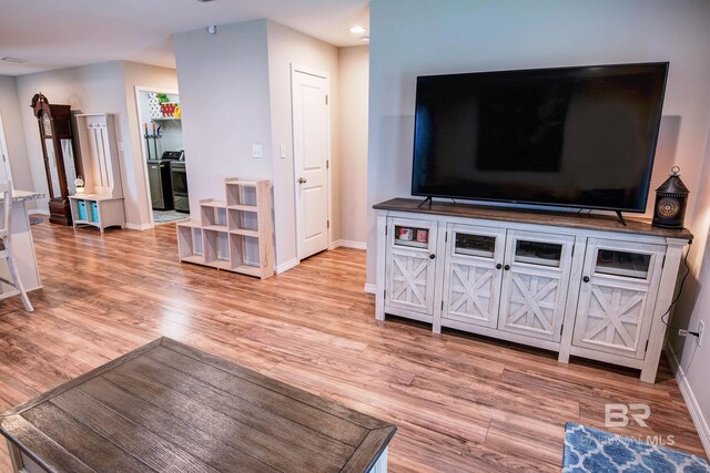 living area with baseboards and light wood-style floors