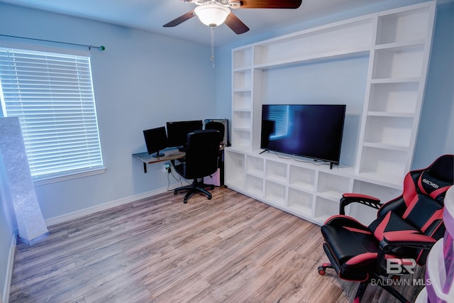 office area with wood finished floors, baseboards, and ceiling fan