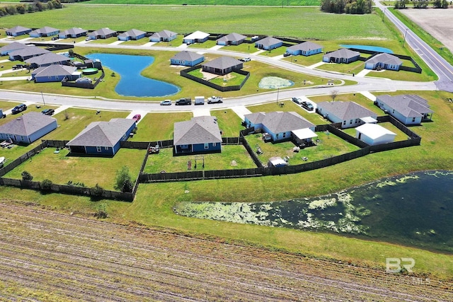 birds eye view of property with a residential view and a water view