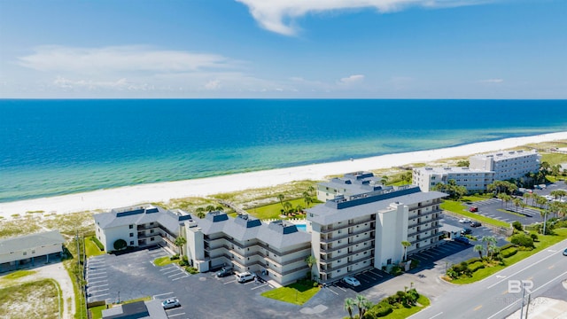 drone / aerial view with a beach view and a water view