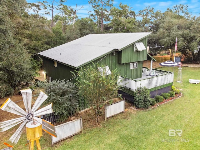 view of home's exterior featuring a lawn and a wooden deck