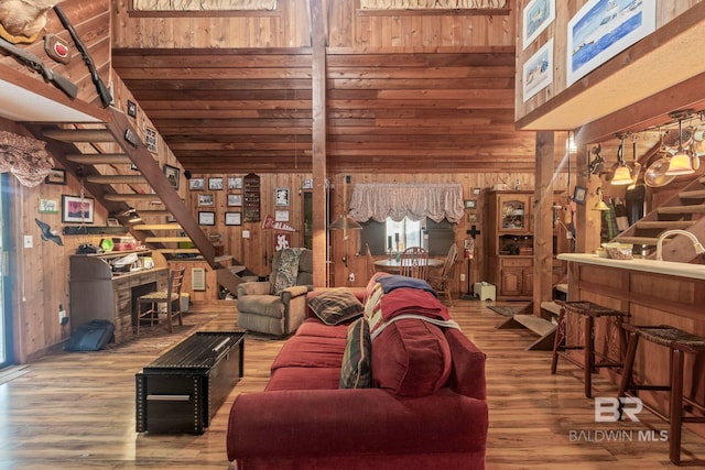 living room with wood walls and hardwood / wood-style floors