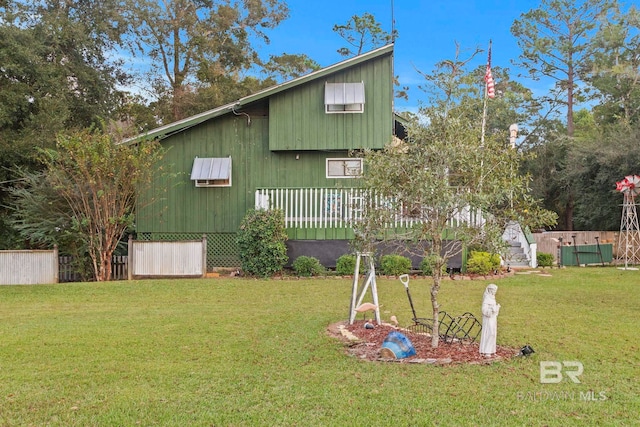 exterior space with a lawn and a wooden deck