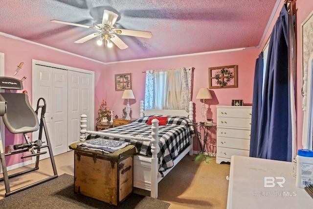 carpeted bedroom featuring ceiling fan, a closet, a textured ceiling, and ornamental molding