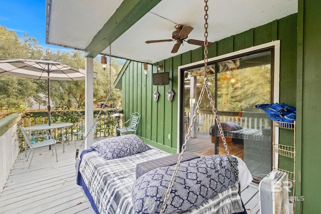 deck with an outdoor living space and ceiling fan