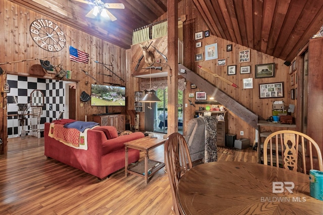 interior space featuring wood walls, wooden ceiling, high vaulted ceiling, hardwood / wood-style flooring, and ceiling fan