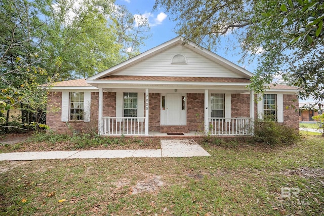 view of front of house with a porch and a front yard