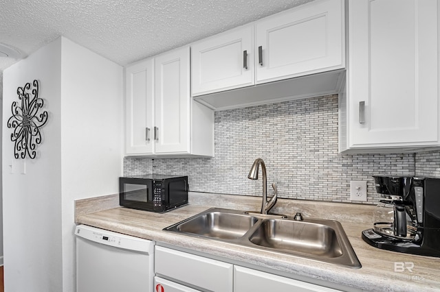 kitchen featuring white cabinets, decorative backsplash, sink, and white dishwasher