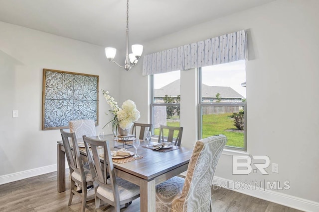 11569 Thistledown Loop, Spanish Fort, AL 36527 - dining space with a chandelier, wood finished floors, and baseboards