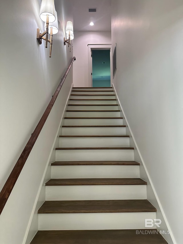 stairs featuring wood-type flooring