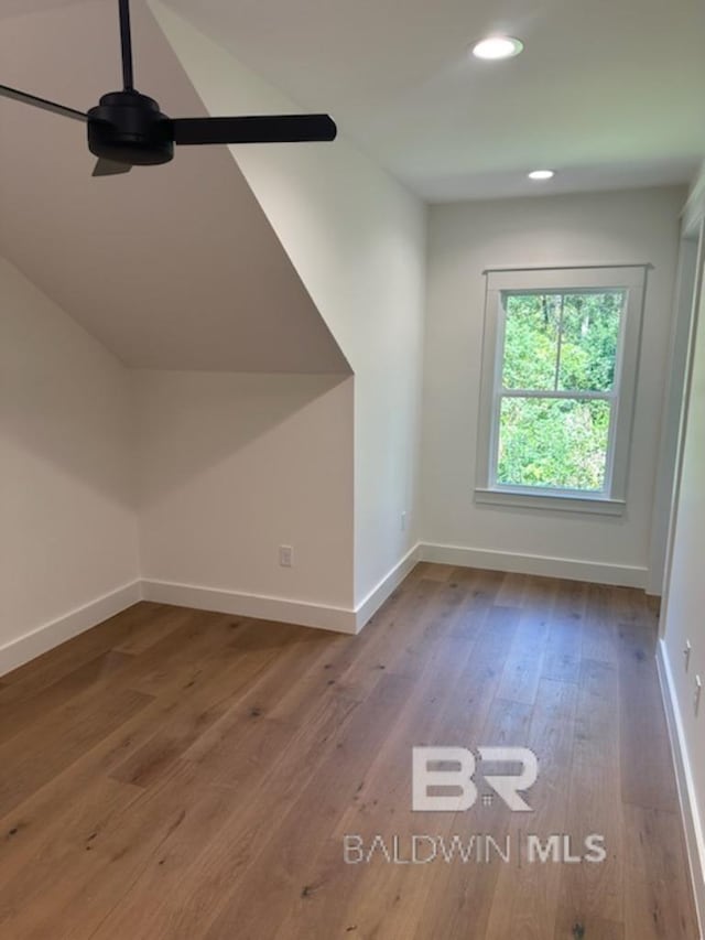 additional living space featuring ceiling fan and hardwood / wood-style flooring