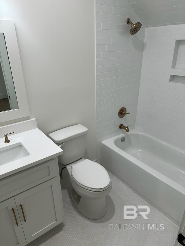 full bathroom with tiled shower / bath, vanity, toilet, and tile patterned floors