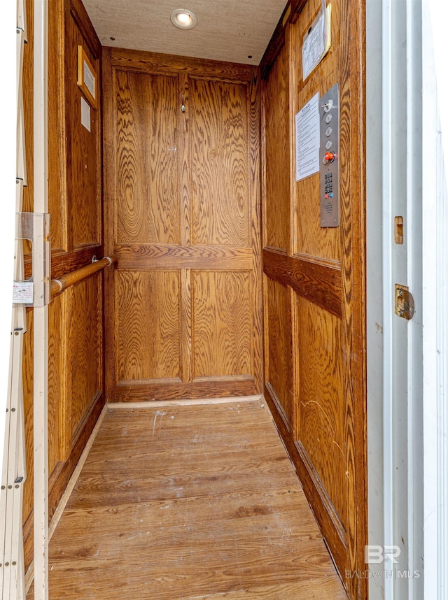 room details featuring wooden walls and elevator