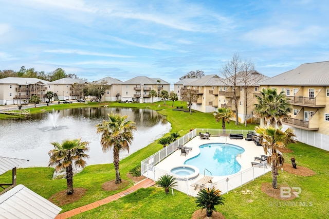 view of swimming pool with a water view and a yard