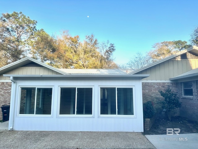 view of side of property featuring brick siding