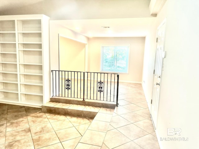 hallway with tile patterned floors and visible vents