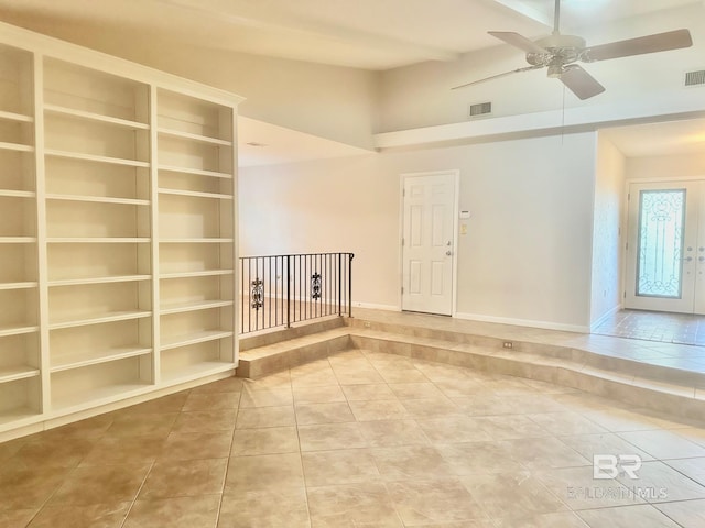 empty room with tile patterned flooring, visible vents, and a ceiling fan