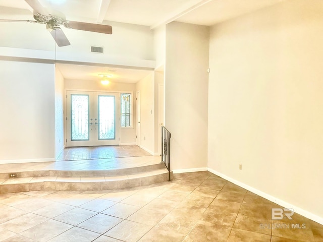 tiled entryway with visible vents, beamed ceiling, french doors, baseboards, and ceiling fan