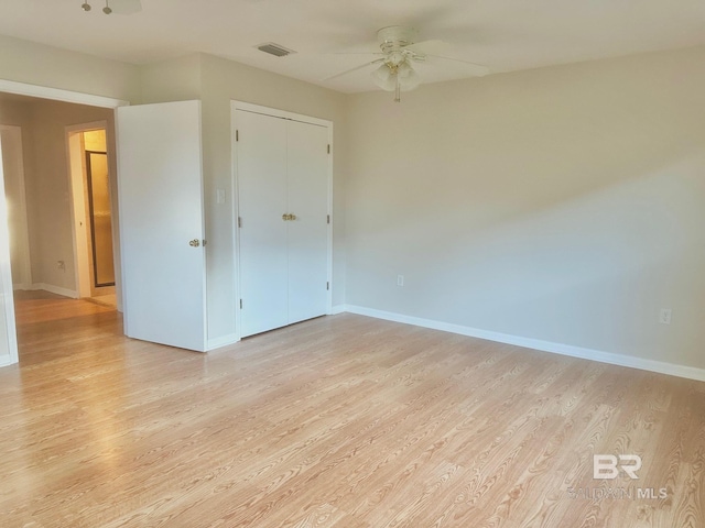 unfurnished room with visible vents, ceiling fan, baseboards, and light wood-style floors