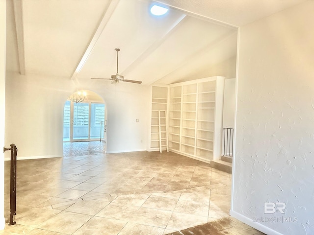 empty room with arched walkways, baseboards, ceiling fan, and vaulted ceiling