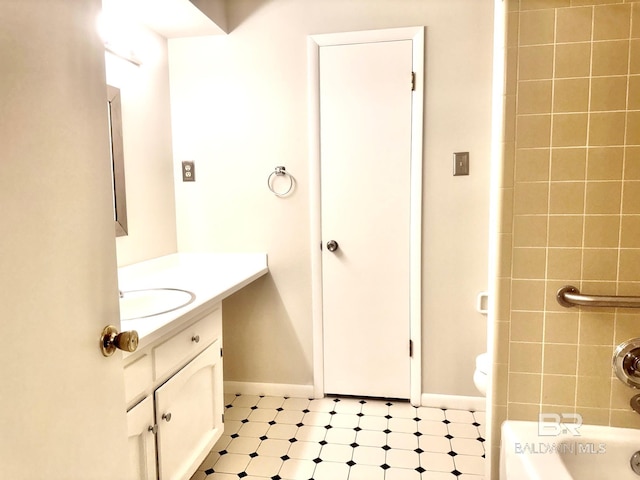 full bathroom featuring vanity, baseboards, and shower / washtub combination