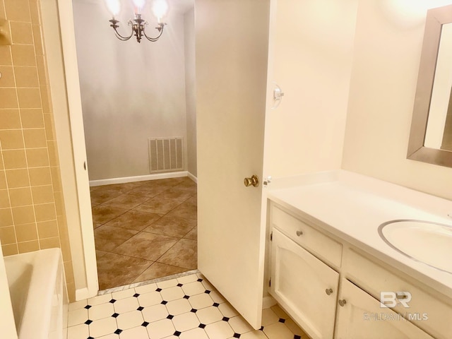 bathroom with visible vents, vanity, and a tub to relax in