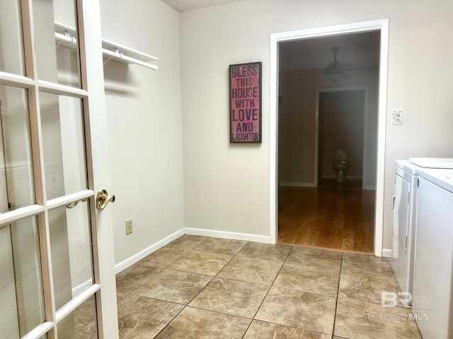 laundry area featuring laundry area, baseboards, and washing machine and clothes dryer