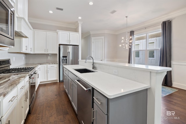 kitchen with white cabinets, sink, a kitchen island with sink, stainless steel appliances, and dark hardwood / wood-style flooring