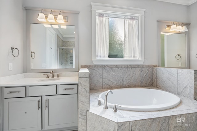 bathroom with crown molding, separate shower and tub, and vanity