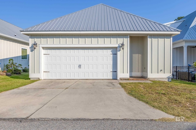 view of front of home with a front yard and a garage