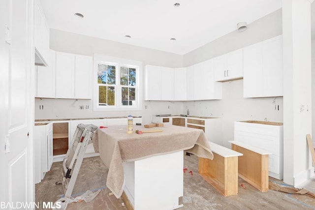 kitchen featuring a center island and white cabinets