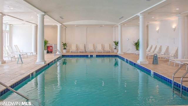 view of swimming pool with ornate columns