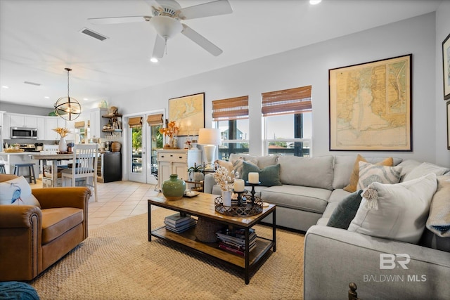 tiled living room with ceiling fan