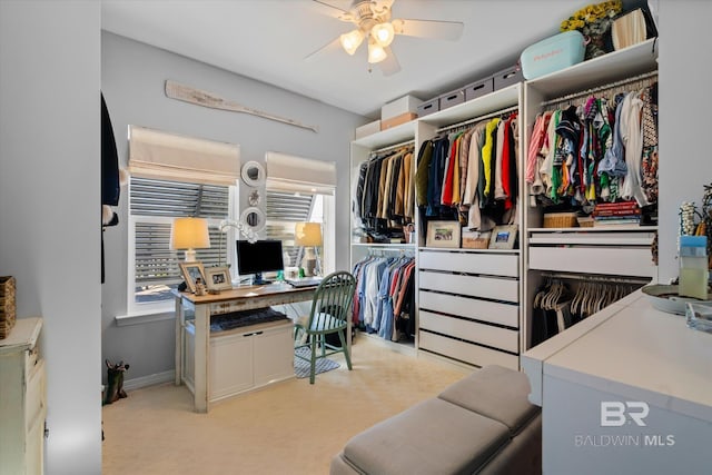 spacious closet featuring light colored carpet and ceiling fan