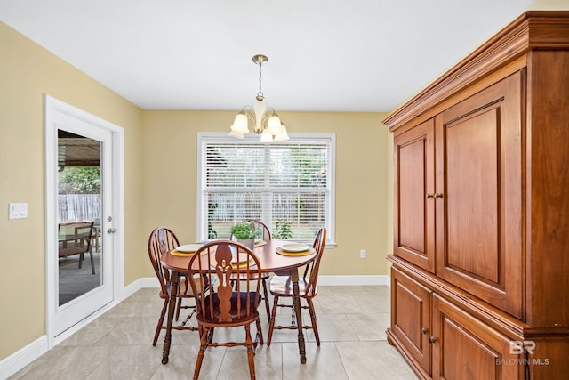 tiled dining space with a chandelier