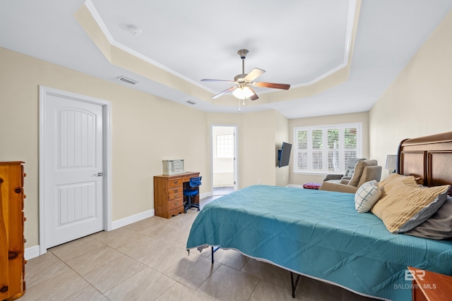 bedroom featuring a raised ceiling, ornamental molding, light tile patterned floors, and ceiling fan