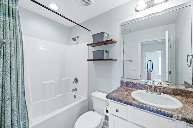 full bathroom featuring vanity, shower / bath combo, and toilet