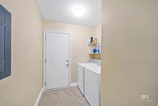 laundry area with separate washer and dryer and light tile patterned floors