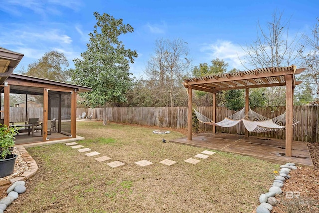 view of yard featuring a patio and a sunroom